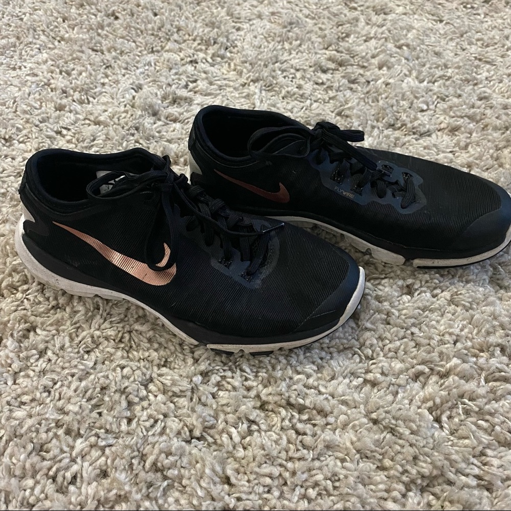 Black and gold Nike tennis shoes